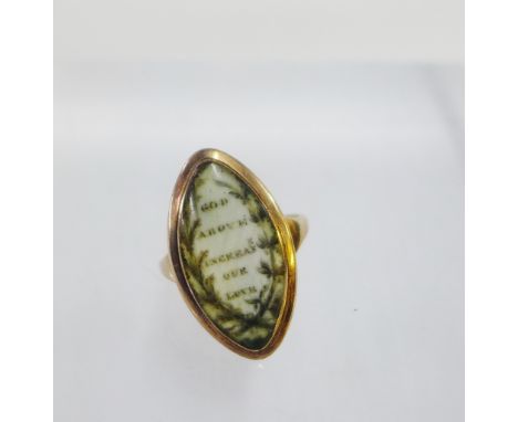 Antique mourning ring, the oval plaque inscribed 'God above increase our love' set within an unmarked gold frame, on a plain 
