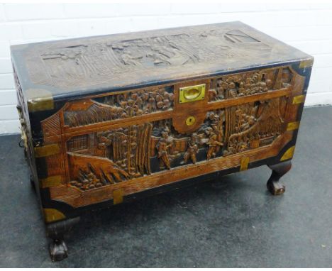 Chinese carved camphor and ebonised wood  trunk with brass mounts and handles, on claw and ball feet, 56 x 90cm 