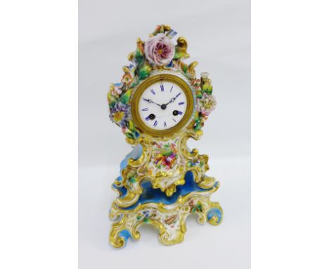 French porcelain mantle clock, the dial inscribed 'Rochat A Paris' with Roman numerals, the floral encrusted porcelain case c