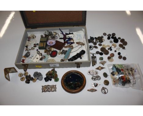 A box containing various costume jewellery, vintage badges, enamel decorated brooches, charm etc. 