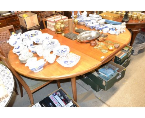 A G-plan extending dining table with centrefold leaf; and a set of four cane backed G-plan chairs 