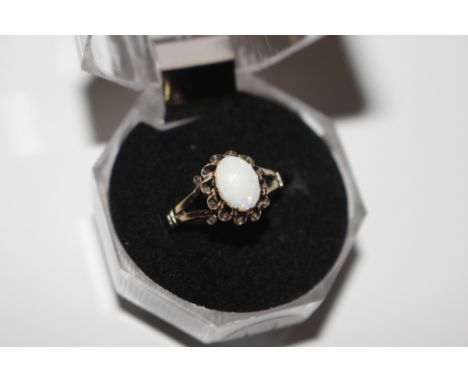 A 9ct gold ring set with a large oval opal stone in fancy setting 