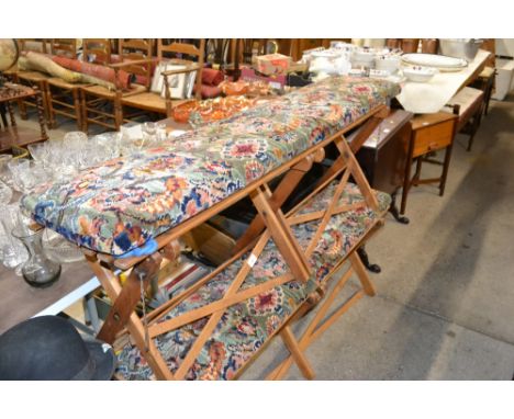 A Folding bench on X frame with rug covered seat