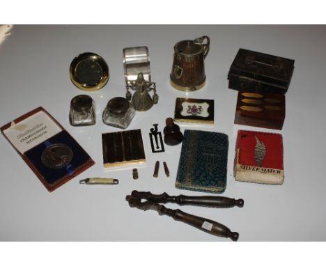 A box containing a pair of wooden handled nut crackers, miniature easel photo frames, and inkwell etc.