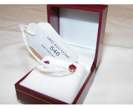 A pair of ruby stud earrings in gold setting
