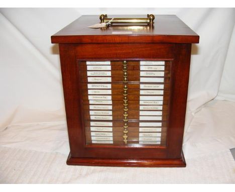 A twenty-one tray antique mahogany coin collector's cabinet enclosed by a glazed door and having brass carry handle by R & J 