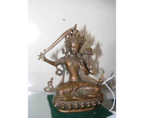 A 14cm high bronze deity figure 