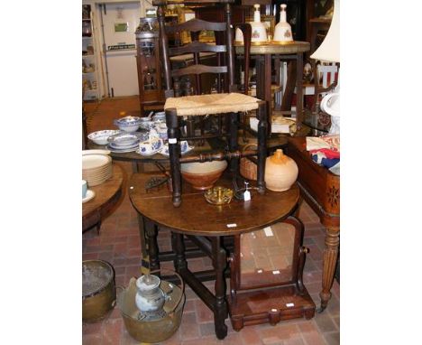 An oak gate-leg dining table together with a chair
