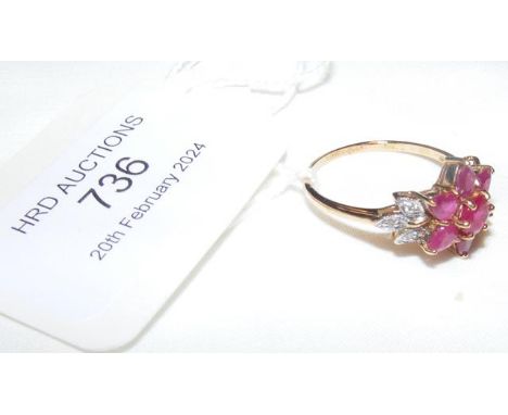 A diamond and ruby 'flower' ring in 9ct setting - approx. size N/O