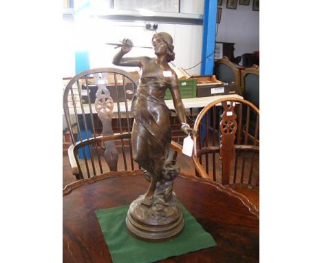 An antique bronze figure of female on rotating base - 56cms high