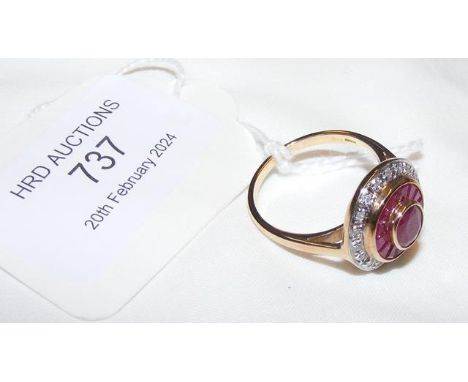 A ruby and diamond circular ring in 9ct setting - approx. size N