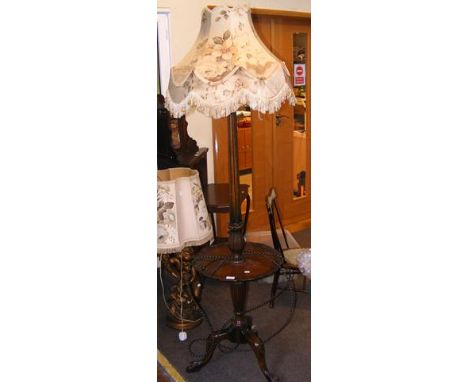 A mahogany standard lamp occasional table on tripod support 