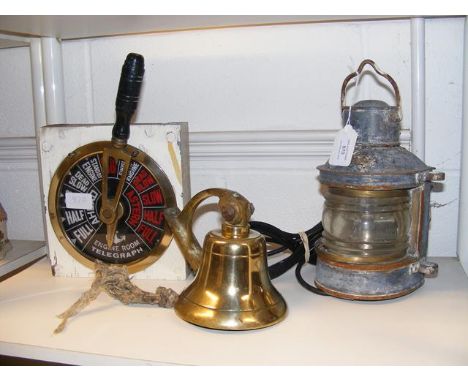 Three items of nautical and marine interest: A vintage brass ship's bell, an engine order telegraph or EOT, and a Masthead li