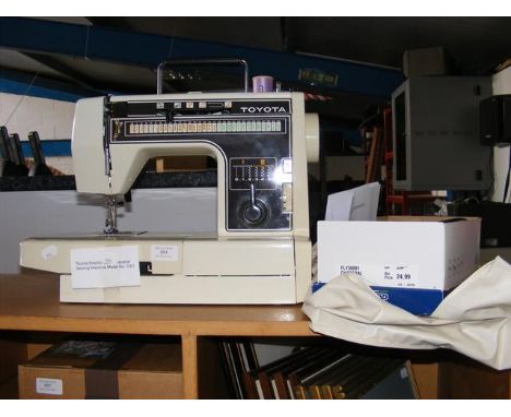 A Toyota electric industrial sewing machine - model No. 7001 with foot pedal