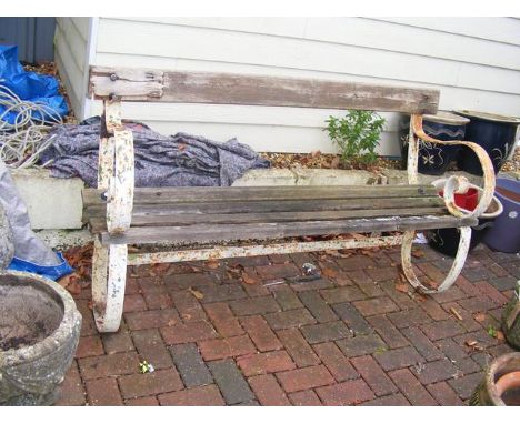 A large garden bench with wrought metal ends - length 142cm 