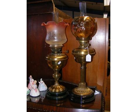 A Victorian oil lamp with glass shade, together with one other