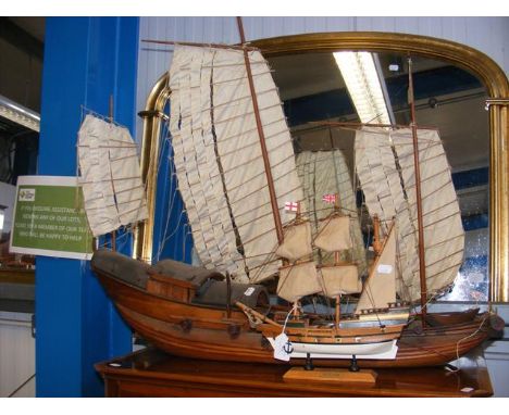 An old carved wooden model of three masted Chinese boat, together with a smaller model of the Mayflower 