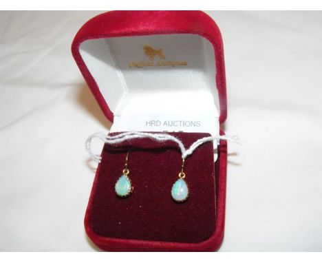 A pair of teardrop shaped opal earrings