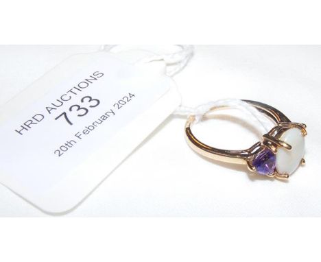 An amethyst and oval opal ring in 9ct mount - approx. size N