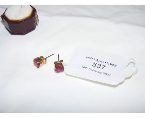 A pair of ruby? earrings in gold mount