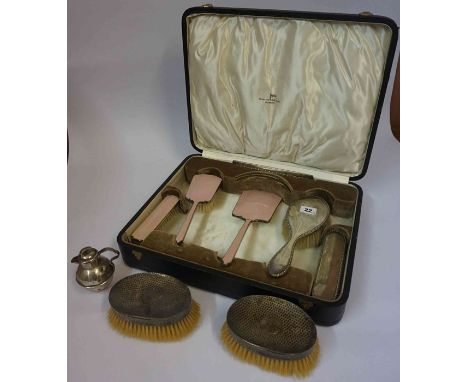 A Pair of Hammered Silver Backed Clothes Brushes, Hallmarks for London, also with a matching silver backed hair and clothes b