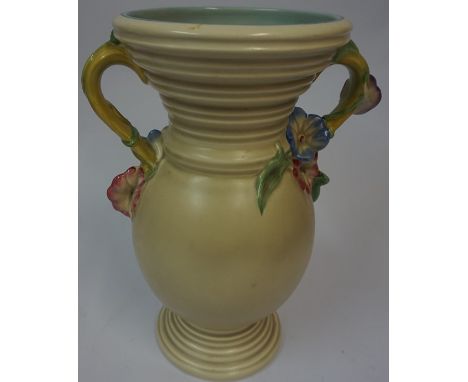 A Large Clarice Cliff for Newport Pottery Vase, Decorated with multi coloured moulded panels of green coloured acorns, on an 