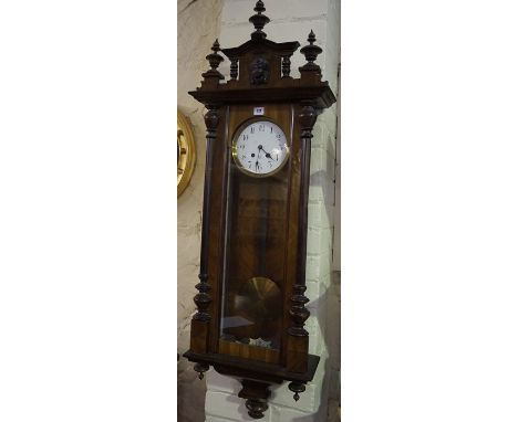A Walnut Cased Vienna Wall Clock, circa early 20th century, having mask decration, white enamel dial with Arabic numerals, wi
