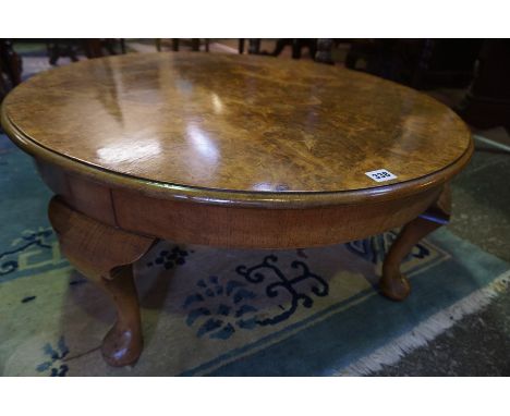 A Figured Walnut Circular Coffee Table, Having label to underside for John Taylor &amp; Son Edinburgh, raised on pad foot, 37