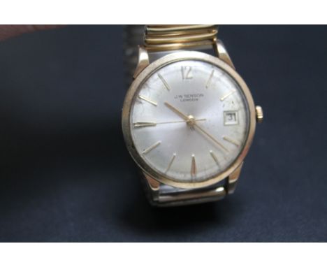 A VINTAGE J W BENSON GOLD DATE WATCH, probably 9 carat, on expandable plated bracelet, presentation engraving to the back cov