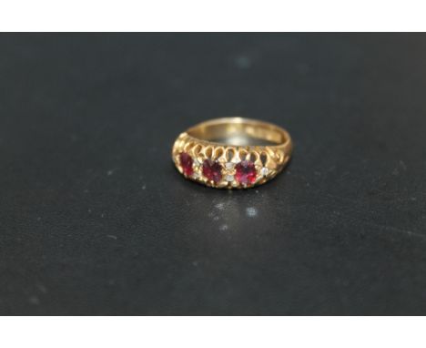 A HALLMARKED 18 CARAT GOLD RING, set with ruby style stones and diamond accents, approx weight 3.1g, ring size L