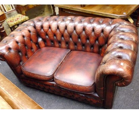 A button leather upholstered two seat chesterfield settee