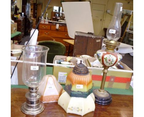 An early 20th century pedestal oil lamp, with brass column and painted reservoir, together with two Edwardian glass shades, s