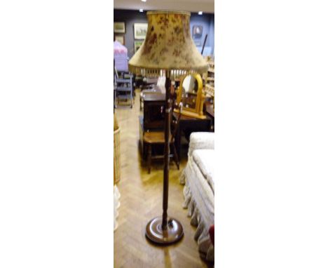A turned wood standard lamp