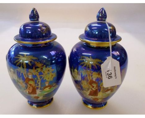 A pair of Carlton ware verdescent lustre covered vases, each decorated with Arabesque figures and landscapes