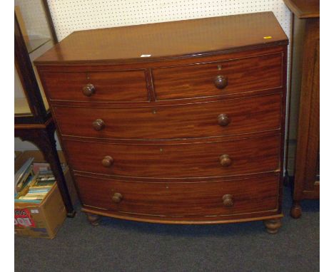 An early 19th century mahogany bow front chest of two short over three long drawers,  raised on bun feet