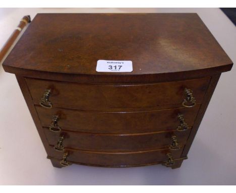 A George III style miniature mahogany and burr walnut chest, of bow front form having four graduated long drawers with brass 