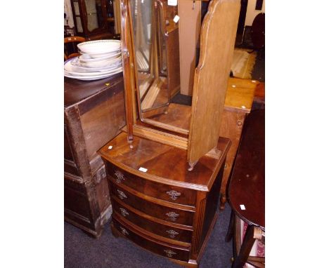 A reproduction mahogany bow front chest of four drawers, together with a walnut folding triptych dressing table mirror