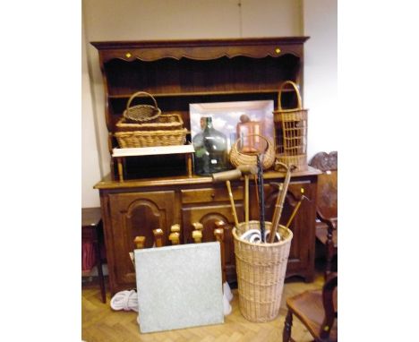 A silver mounted malacca swagger stick, together with other walking sticks, canes, croquet mallets, wicker baskets, and other