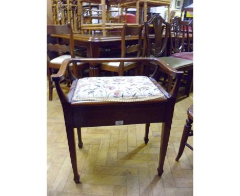 An Edwardian mahogany bow backed piano seat, with hinged seat and square supports