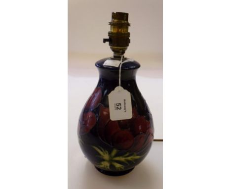 A Moorcroft pottery table lamp, of baluster form, decorated with red and mauve anemone on a deep blue ground, 26cm (including