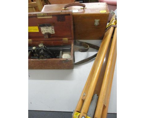 A Theodolite and tripod and a stereoscope in a case 