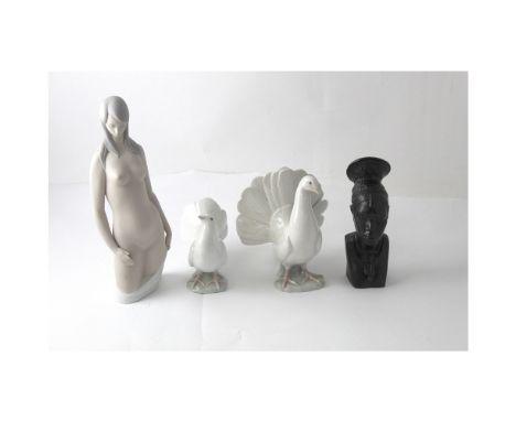 Four Lladró figures to include a large nude female figure, two doves and an African female bust (af) (4). CONDITION REPORT Th