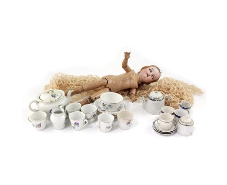 Armand Marseille; a bisque head doll with articulated limbs and composite body, model 390 and a basket containing a children'