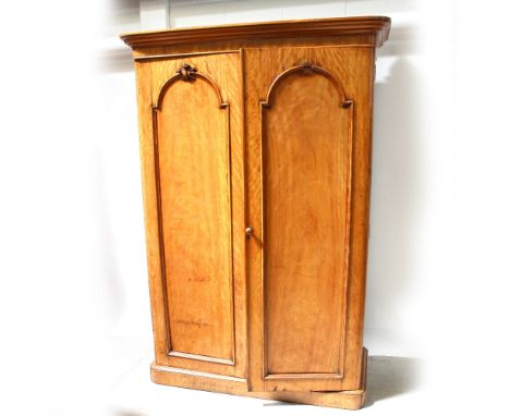 A Victorian satin walnut two-door rounded-corner wardrobe with arched panel doors and flared cornice, height 206cm.
