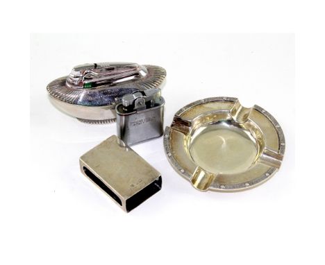An Elizabeth II hallmarked silver ashtray with Celtic design rim, Dublin 1965, approx 2.6ozt, two vintage cigarette lighters,