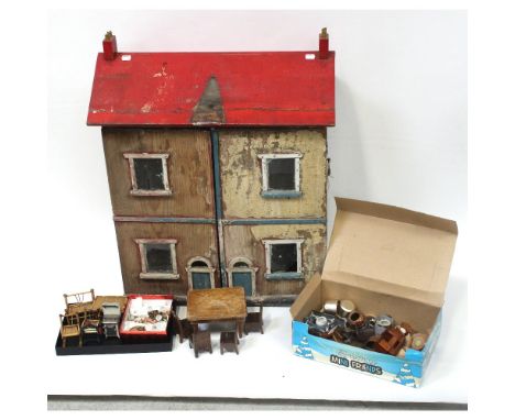 A vintage dolls' house with double front opening (af) and a quantity of dolls' furniture and accessories to include a longcas
