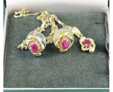 An 18ct gold link chain with ruby pendant in a swirling frame and a pair of matching stud earrings, combined approx 3g.