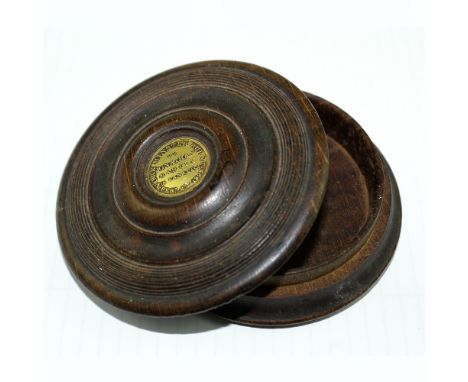 A turned wooden snuff/tobacco box with brass plaque 'York Minster Burned by Jonathan Martin February 2nd 1829', paper label t