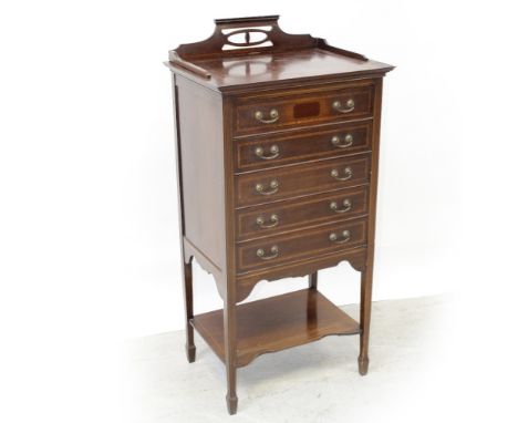 An Edwardian mahogany five-drawer music cabinet with galleried top supported on square tapering legs to spade feet united by 