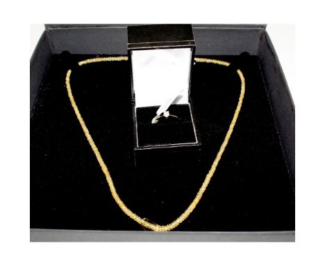 A 10ct gold ladies' dress ring set with white solitaire stone, size R, approx 1.6g and a yellow sapphire necklace with 9ct go